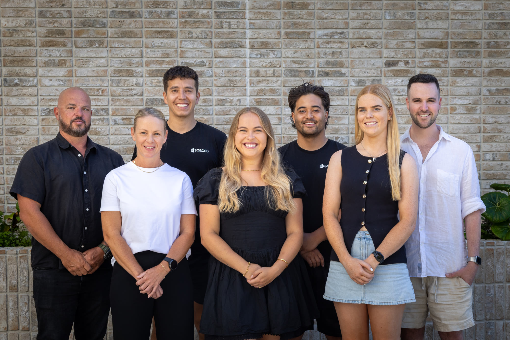 Spaces team members together outside the Auckland workplace